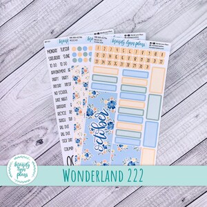 May include: Three sheets of planner stickers featuring a floral theme with blue and peach tones. The sheets include calendar dates for October, various rectangular labels, circular dots, and text labels for days of the week and common tasks.