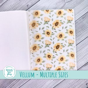May include: Open notebook with grid paper on the left and a vellum sheet on the right. The vellum features a repeating pattern of yellow sunflowers and green leaves on a white background. The text "VELLUM - MULTIPLE SIZES" is displayed at the bottom.