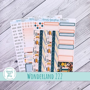 May include: Three sheets of Mandy Lynn Plans planner stickers featuring the Wonderland 222 theme. The set includes text labels, date circles, functional boxes, and decorative strips with patterns of books, flowers, and solid muted colors.