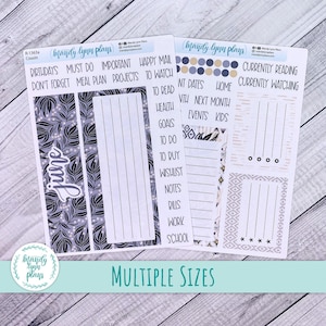 May include: Planner stickers with various designs and text. The stickers include floral patterns, lists, and labels such as "Birthdays," "To Do," and "Currently Reading." The stickers are in shades of blue, gray, and white, with the text "June" on one sheet.