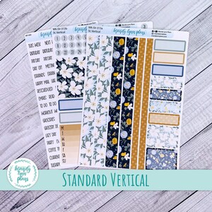May include: A set of planner stickers with a floral design. The stickers are in a variety of colours, including blue, white, yellow, and black. The stickers are designed for use in a vertical planner. The stickers include text such as "This Week", "Next", "Birthday", "Payday", "Day Off", "Meeting", "Errands", "Happy Mail", "Rescheduled", "Emails Read", "To Do", "Workout", "Groceries", "Grocery Day", "Lazy Day", "Party", "Coffee", "Current", "Therapy", "M", "T", "W", "Th", "F", "Sa", "Su", "1", "2", "3", "4", "5", "21", "22", "23", "24".