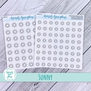 May include: Two sheets of white sticker paper with black sun icons. The sticker sheets are labeled "Mandy Lynn Plans" and "WEA-W-101". The text "SUNNY" is printed below the sticker sheets.