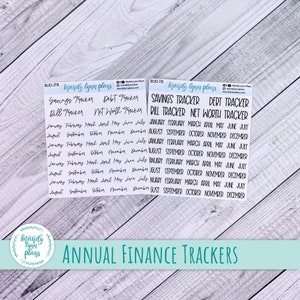 May include: A sheet of clear stickers with black text. The stickers are for a financial planner and include titles like "Savings Tracker", "Debt Tracker", "Bill Tracker", and "Net Worth Tracker". The stickers also include the months of the year, January through December.