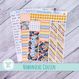 May include: A set of planner stickers featuring floral, striped, and solid designs. The stickers include the word "November" and calendar dates. The phrase "Hobonichi Cousin" is also visible. The stickers are designed for planning and organization.