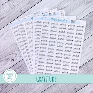 May include: Several sheets of stickers with the word "Gratitude" in a handwritten font. The stickers are white with black text. The image also includes the "Mandy Lynn Plans" logo in a circle.