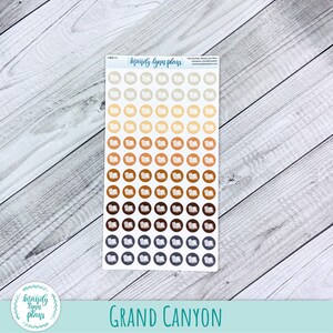 May include: A sheet of 100 book-shaped stickers in various shades of brown, beige, and grey. The stickers are arranged in rows and columns. The text "Mandy Lynn Plans" is printed at the top of the sheet.