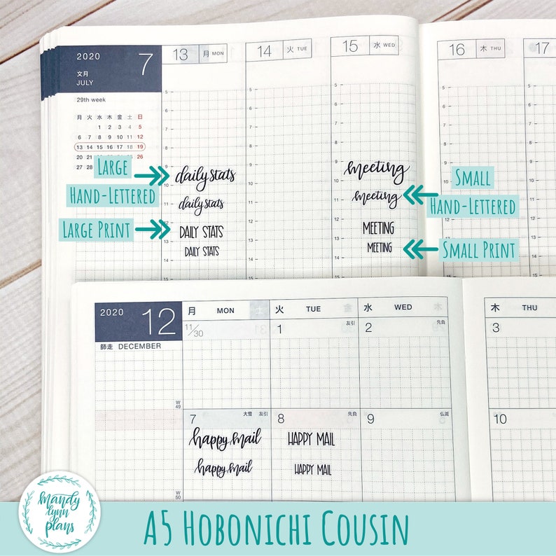 May include: An open A5 Hobonichi Cousin planner featuring grid-lined pages with July and December calendar layouts. The pages display various black ink text samples including daily stats, meeting, and happy mail in large and small print styles.