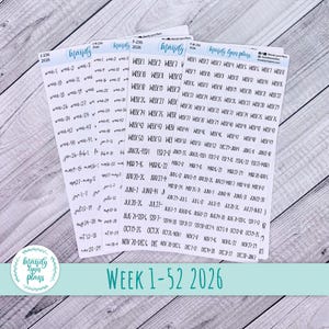 May include: A set of planner stickers with handwritten text, including dates and week numbers for the year 2026. The stickers are white with a light blue logo and text, and the phrase "WEEK 1-52 2026" is displayed.