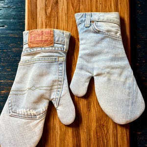 May include: A set of three ceramic mugs with a speckled, matte finish. The mugs are in shades of cream, light gray, and dark gray. Each mug has a simple, minimalist design, perfect for coffee or tea.