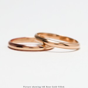 May include: Two gold-filled wedding bands, one on top of the other, on a white background. Picture showing 14K Rose Gold-Filled. Available in 14K Gold-Filled, 14K Rose Gold-Filled, and Sterling Silver.