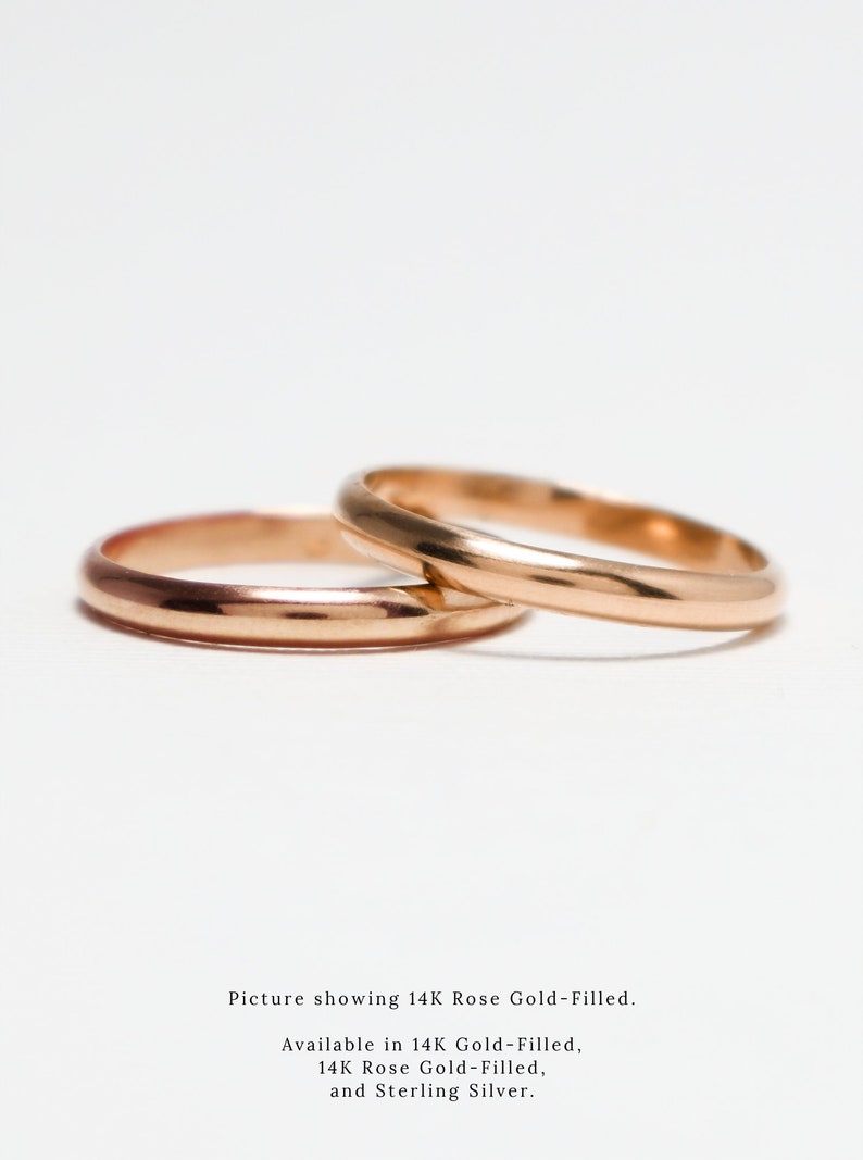 May include: Two gold-filled wedding bands, one on top of the other, on a white background. Picture showing 14K Rose Gold-Filled. Available in 14K Gold-Filled, 14K Rose Gold-Filled, and Sterling Silver.