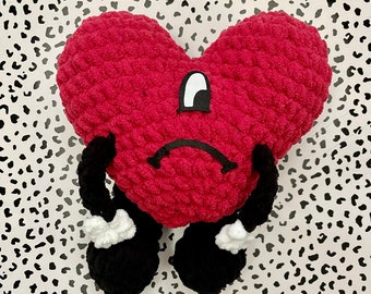 thumbnail interactive-video image 1 of Bad Bunny 'Un Verano Sin Ti' Cute Heart Shaped Plush - Red Bunny Cushion 1 of 3