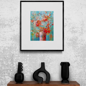 May include: A framed abstract painting of a bouquet of red, orange, and pink flowers in a white vase against a blue background.