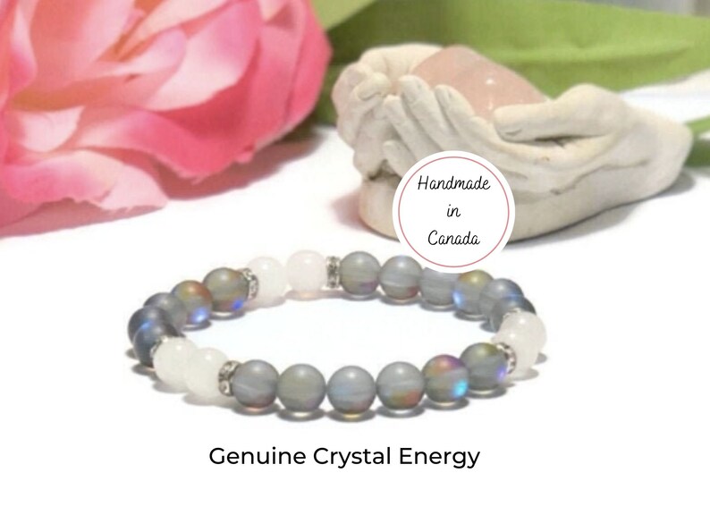 May include: A gray and white crystal beaded bracelet with iridescent beads. The bracelet is handmade in Canada. Genuine Crystal Energy.