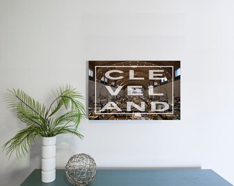 May include: A photograph of the interior of the West Side Market in Cleveland, Ohio. The image is a wide shot of the market, with the text "CLEVELAND" superimposed over the image.