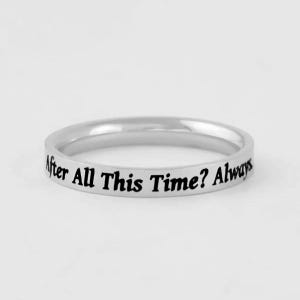 May include: A silver-toned metal band ring featuring a smooth, polished finish. The outer surface of the ring is engraved with the black text "After All This Time? Always" in a decorative, flowing script font that wraps around the circumference.