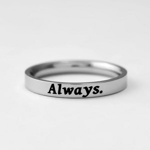May include: A silver band ring with the word "Always." engraved on the top.
