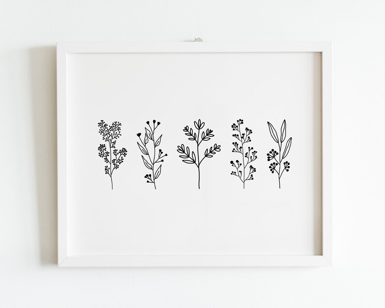 May include: A white framed print with five black line drawings of different types of plants. The plants are stylized and simple.