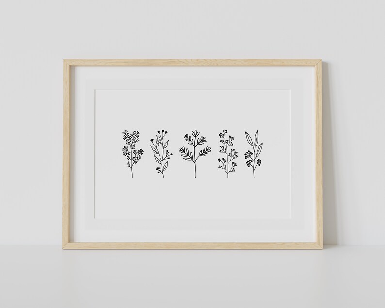 May include: A framed print with a minimalist black and white illustration of five different types of foliage.