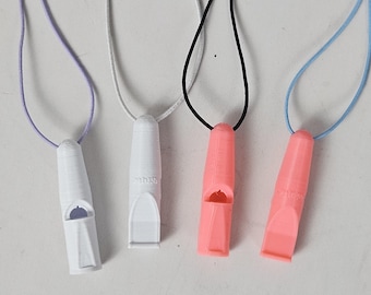 May include: Four dog whistles with different coloured cords. The whistles are white and have a small hole on the side. The cords are purple, white, black, and light blue.