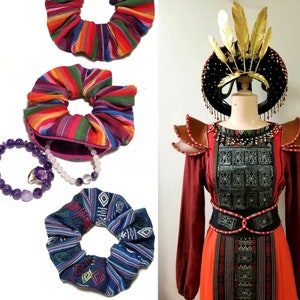 May include: Three colorful fabric hair scrunchies with a purple and white beaded bracelet. A woman wearing a red and black traditional costume with a gold headdress and a silver chest plate.