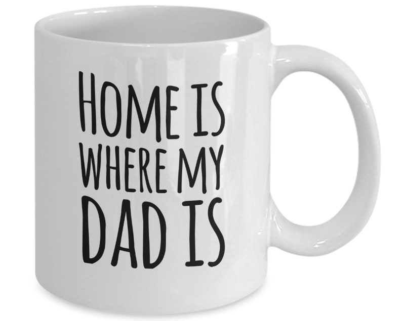 May include: White ceramic coffee mug with black text that reads "Home is where my dad is".