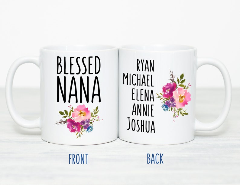 May include: White ceramic mug with the text "Blessed Nana" and a floral design on the front. The back of the mug has the names Ryan, Michael, Elena, Annie, and Joshua.