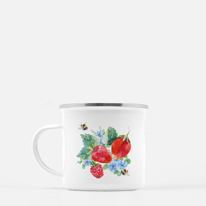 May include: White enamel mug featuring a watercolour design of strawberries, raspberries, and bees on a green leafy background.