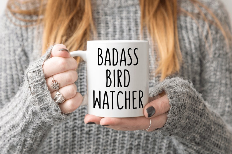 May include: White ceramic mug with black text that reads "Badass Bird Watcher".