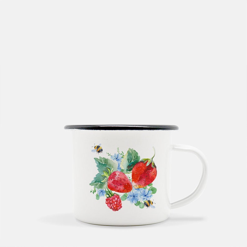 May include: White enamel mug with a black rim and handle. The mug features a watercolour illustration of strawberries, raspberries, and bees on a white background.