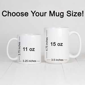May include: Two white ceramic mugs with black text showing the size and volume of each mug. The smaller mug is 11 oz and 3.25 inches wide. The larger mug is 15 oz and 3.5 inches wide.