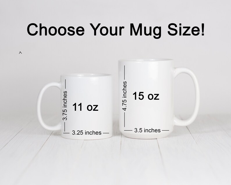 May include: Two white ceramic mugs with black text showing the size and volume of each mug. The smaller mug is 11 oz and 3.25 inches wide. The larger mug is 15 oz and 3.5 inches wide.