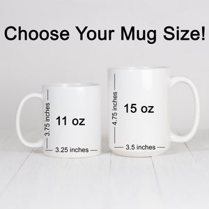 May include: Two white ceramic mugs with black text showing the size and volume of each mug. The smaller mug is 11 oz and 3.25 inches wide. The larger mug is 15 oz and 3.5 inches wide.