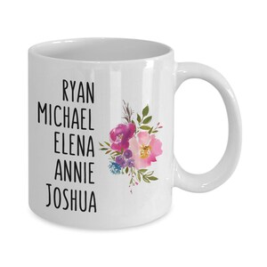 May include: White ceramic coffee mug with a floral design and the names Ryan, Michael, Elena, Annie, and Joshua printed in black.