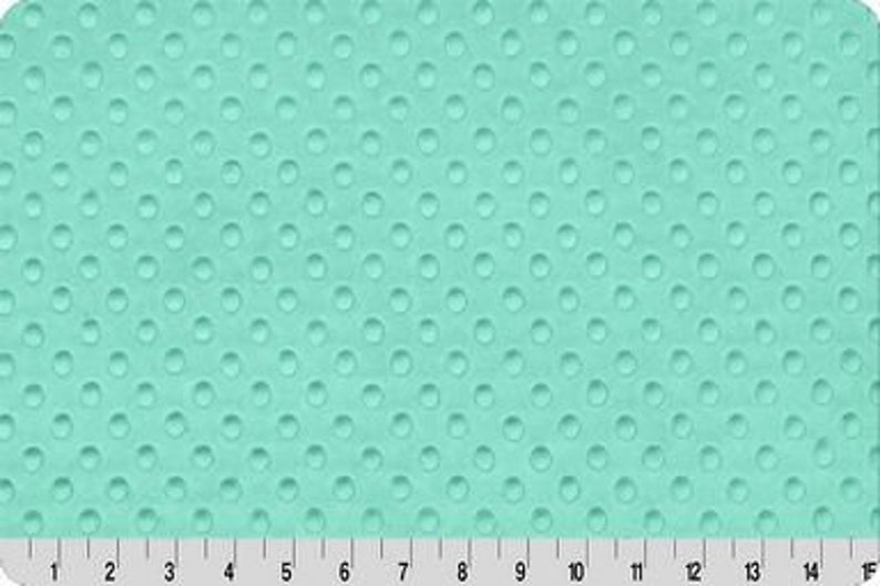 May include: A turquoise blue fabric with a textured pattern of small, raised circles.