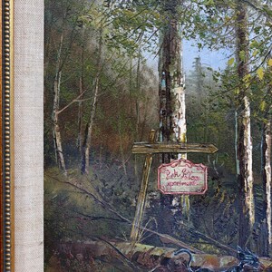 May include: Oil painting of a forest scene with a sign that reads "Pink Palace apartments." A black cat sculpture is in the foreground. The painting is in a gold-colored frame.