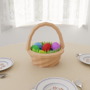 May include: A brown wicker basket filled with colorful Easter eggs and green grass. The basket is sitting on a beige tablecloth with two white plates and silverware.