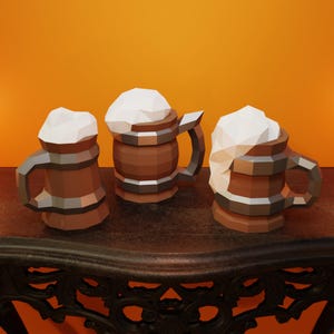 May include: Three brown ceramic beer steins with white foam on top, sitting on a dark wooden table.