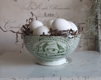 A very old porcelain bowl with a green printed decor