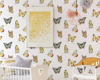May include: A white nursery with a crib and a chair. The walls are covered in wallpaper with a pattern of yellow butterflies. There is a framed picture on the wall with a yellow and white abstract design.
