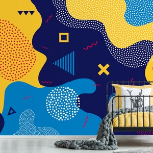May include: Abstract geometric pattern wallpaper with yellow, blue, and red shapes on a dark blue background. The wallpaper features a variety of geometric shapes, including circles, squares, triangles, and wavy lines.