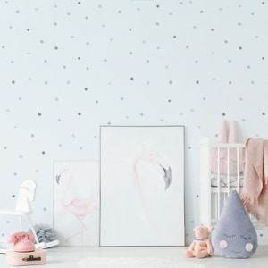 May include: A light blue nursery with a white crib, a rocking horse, and two framed watercolor paintings of pink flamingos. The walls are decorated with a light blue and gray polka dot pattern.