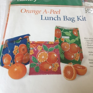 Vintage Lunch Bags Kit. 2004 Orange A-Peel Lunch Bag Kit. From Sewing With Nancy. Includes 3 Oilcloth Fabrics and Three Spools of Thread.