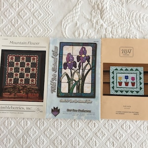 Flower Quilt Patterns. Mountain Flower by Thimbleberries, Inc. Wild Iris Stained Glass by Bear Paw Prod., or Posy Pots by MH Designs.