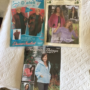 May include: Three sewing patterns for jackets and cardigans. The first pattern is for a Deco Jacket with two lengths included. The second pattern is for a Cuddle Up Cardigan that sews up in one hour. The third pattern is for a Favorite Things cardigan.