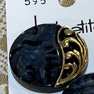 May include: A pair of round earrings with a dark blue marbled design and gold-colored filigree accents. The earrings are on a white tag with the number 595.