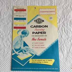May include: A package of Traum carbon tracing paper for dressmaker's use containing 9 assorted sheets. The yellow, white, and blue packaging features an illustration of a person tracing a pattern and text including New Formula and 39 cents.