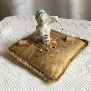 Antique Lady Pin Cushion. Victorian Porcelain Lady in Center of Square Pillow Pin Cushion. Two Old Wood Spools. Ruffle Around Waist.