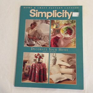 May include: A magazine cover for Simplicity Home & Craft Pattern Catalog, featuring the text "Decorate Your Home easily & affordably". The cover features three images: a woman making a pillow, a table setting with red and white striped tablecloth, and a stack of pillows and a bolster.