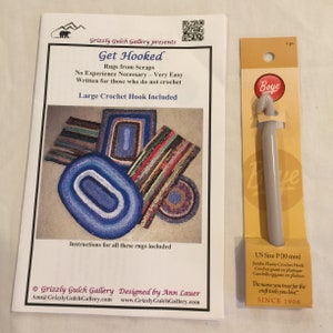 May include: A crochet rug pattern booklet with instructions for making rugs from scraps. The booklet includes a large crochet hook and a photo of four different rugs. The text on the cover reads "Get Hooked" and "Grizzly Gulch Gallery presents".
